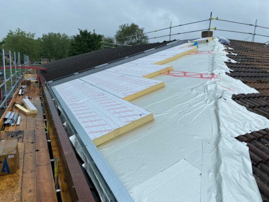 Standing Seam metal roof installed over traditional tile roof with rigid insulation