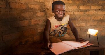 Child with solar pv lights. Project delivers solar lights to Zambian families living without electricity