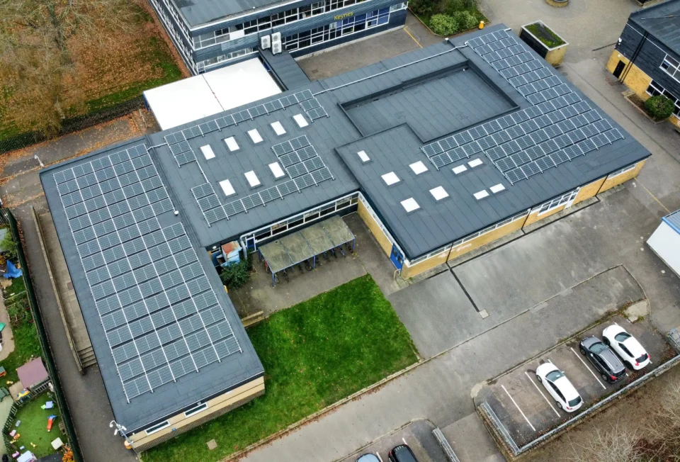 Aerial view of school building with solar panels on roof