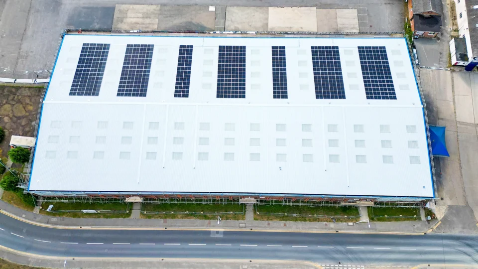 Aerial view industrial warehouse rooftop solar panel installation facility