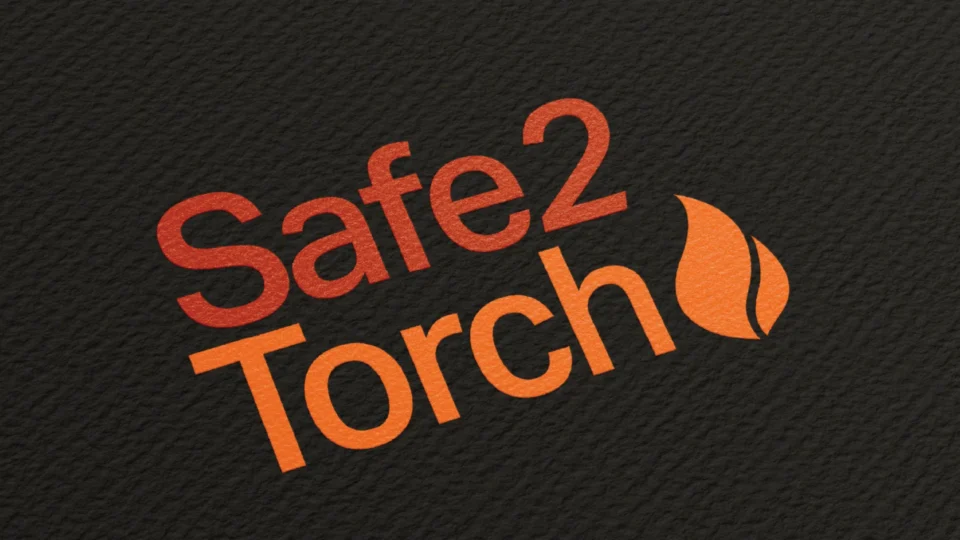 Safe2Torch logo with red and orange flame design on dark background