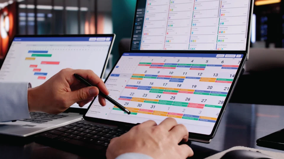 Project manager reviewing colorful Gantt chart timeline on tablet with stylus
