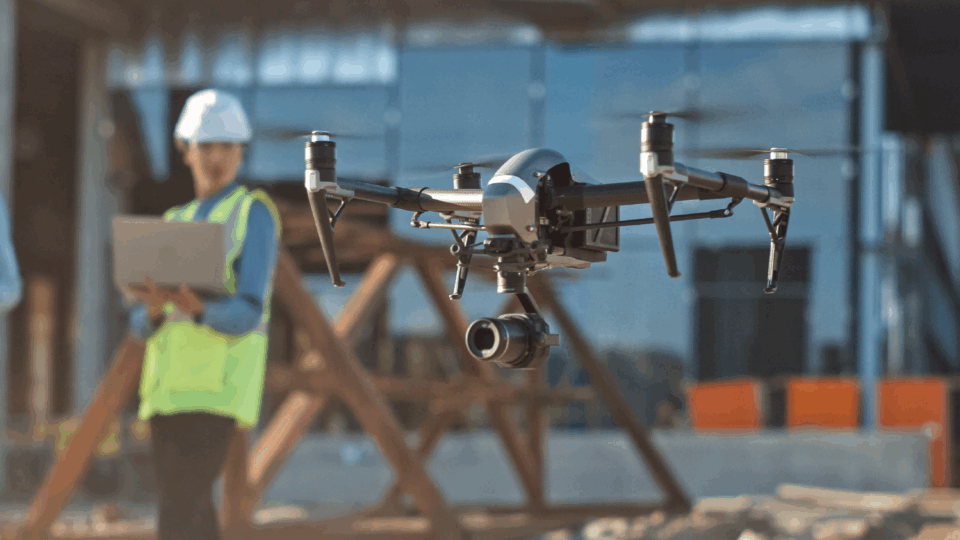 Construction worker operating drone for site survey and inspection