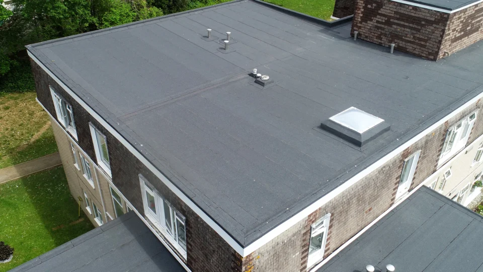 Aerial view flat roof with skylights and ventilation pipes installed