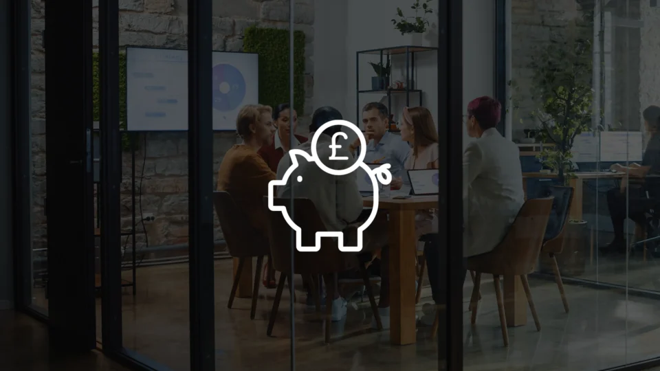 Piggy bank icon with pound symbol overlaying business meeting in modern office