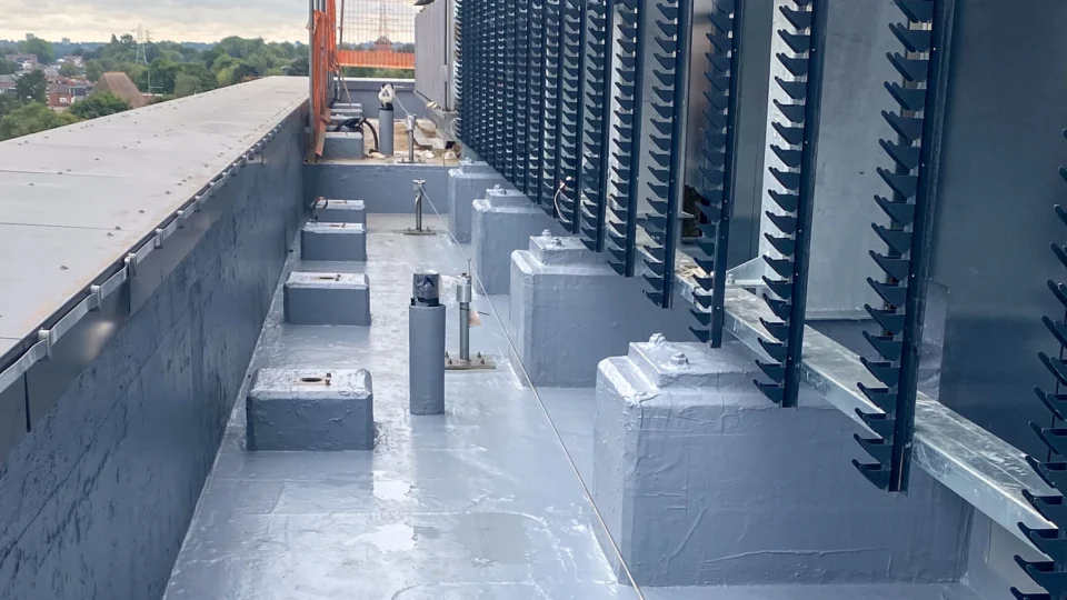 Flat roof with waterproof membrane, metal railings, and HVAC equipment installation