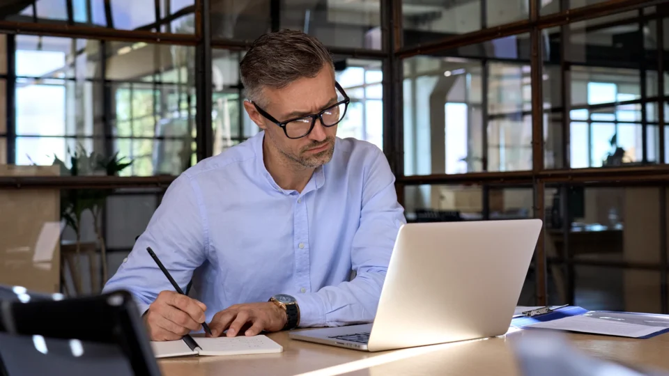 Professional man working on laptop during online CPD session