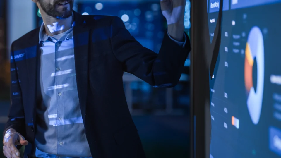 Professional man examining digital analytics dashboard with data visualization charts