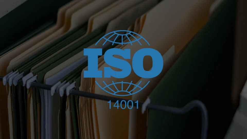 ISO 14001 certification logo with globe symbol on clothing rack background