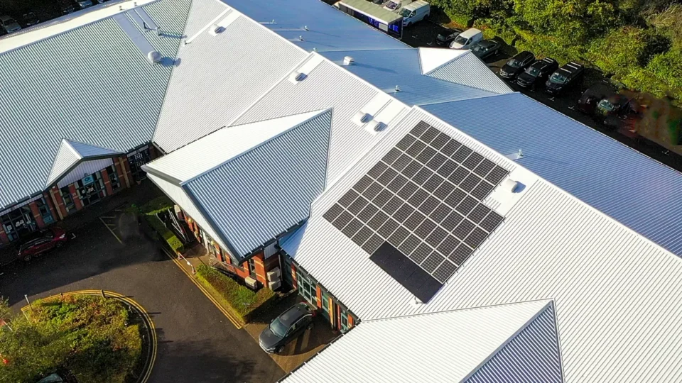 Aerial view of metal roofed enterprise centre with solar panels installed