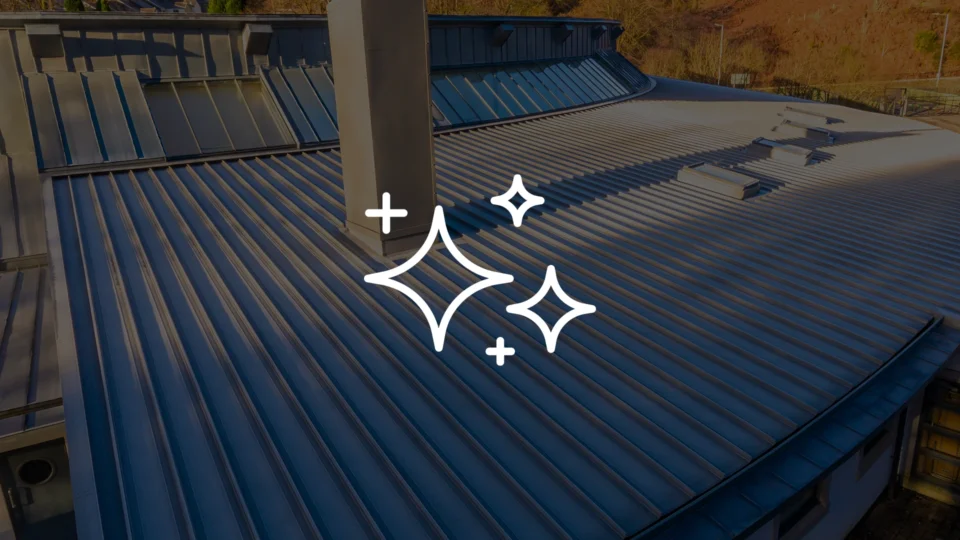 Aerial view of modern metal roofing installation with blue corrugated panels
