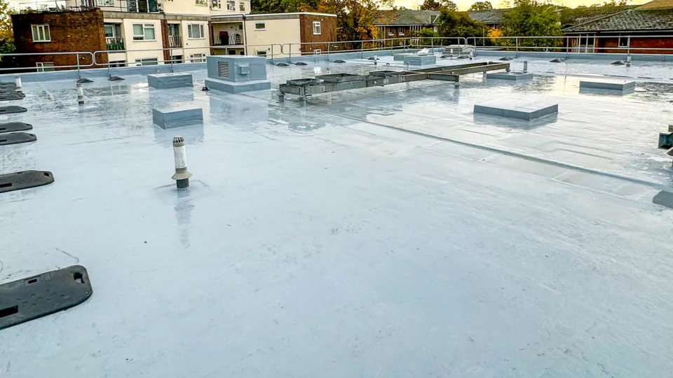Flat roof with light gray membrane coating and various mechanical installations