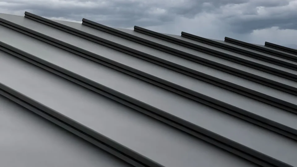 Modern metal roof with parallel ridges and cloudy sky background