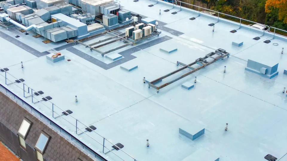 Aerial view commercial flat roof with HVAC units and safety equipment