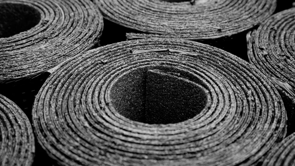 Rolled rubber matting showing concentric circular layers and hollow center opening