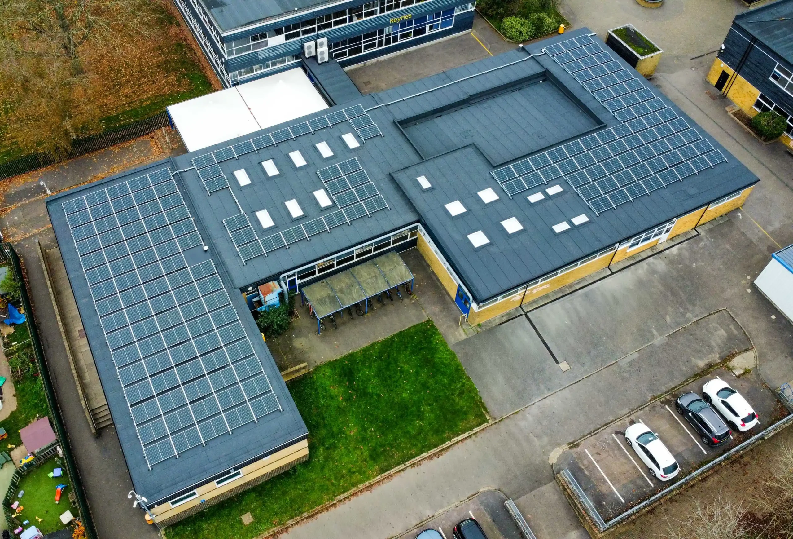 Aerial view of industrial building with extensive solar panel roof installation
