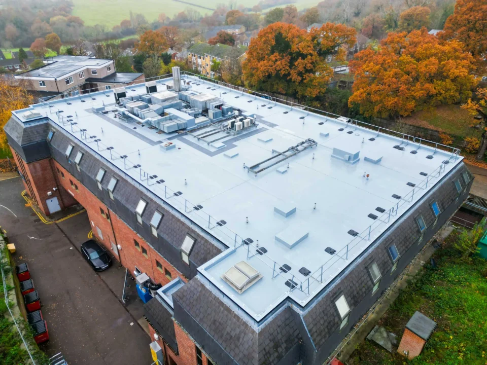 Aerial view of modern flat roof building with HVAC systems and equipment