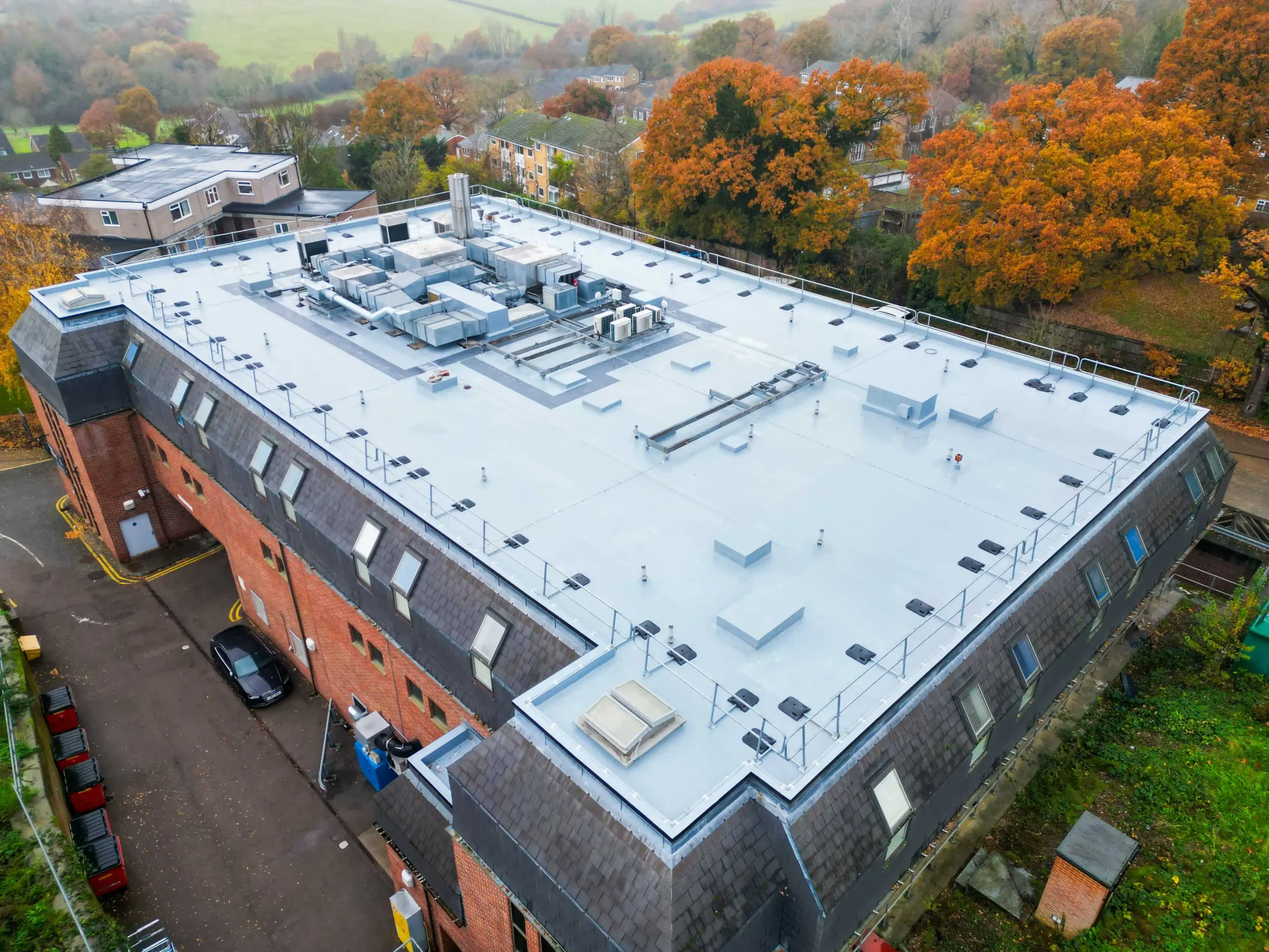 Aerial view of modern flat roof building with HVAC systems and equipment