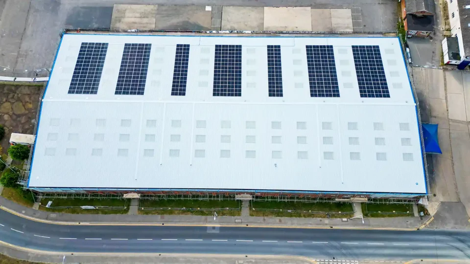 Aerial view industrial warehouse rooftop solar panel installation