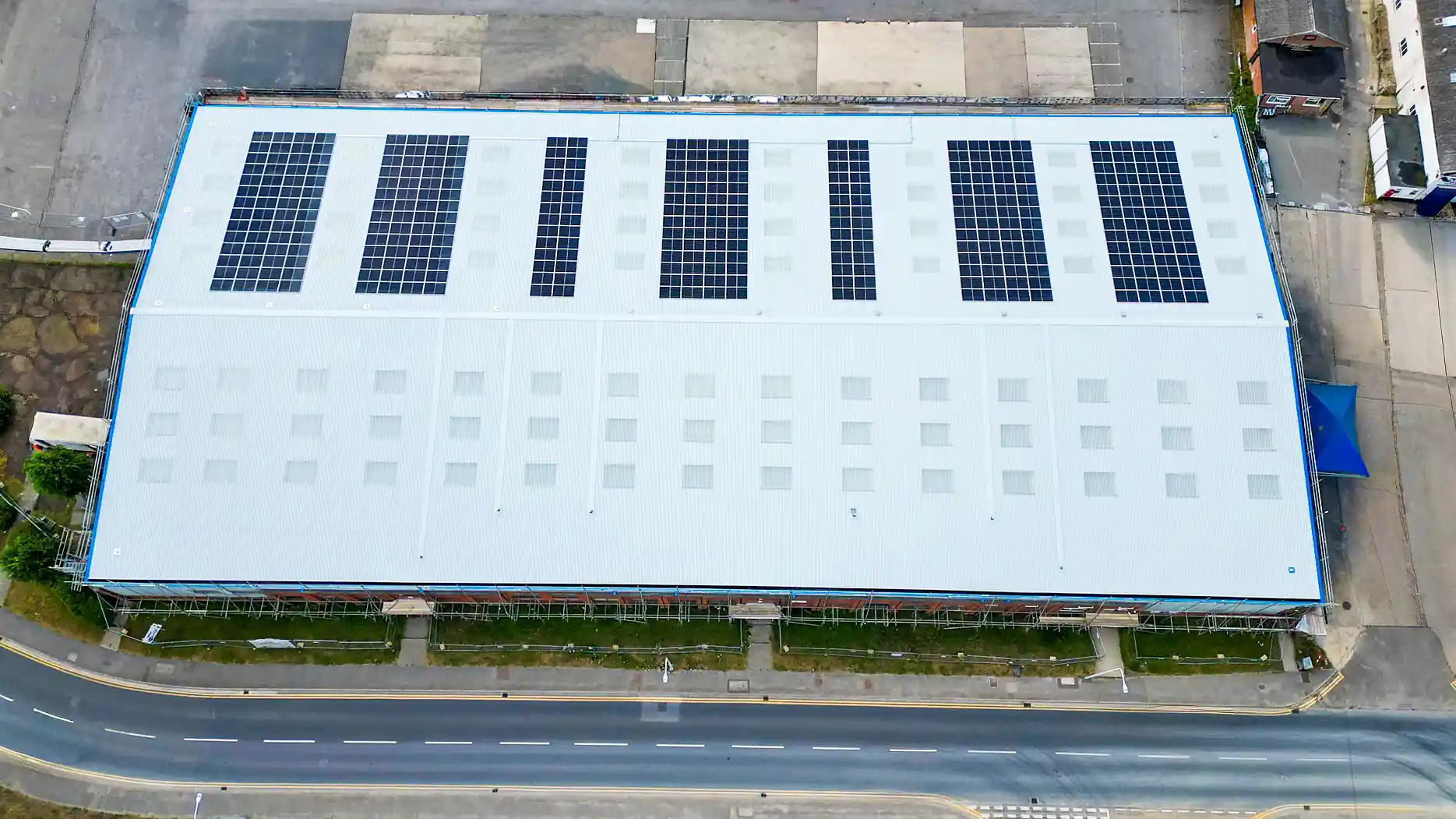 Aerial view industrial warehouse rooftop solar panel installation